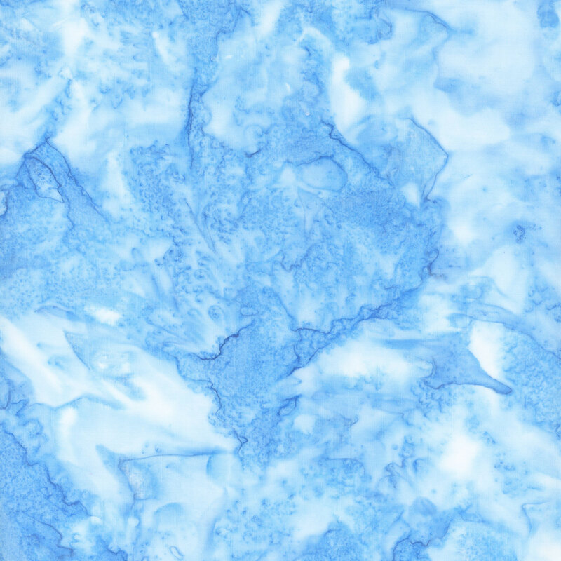Marbled batik fabric in shades of light blue.