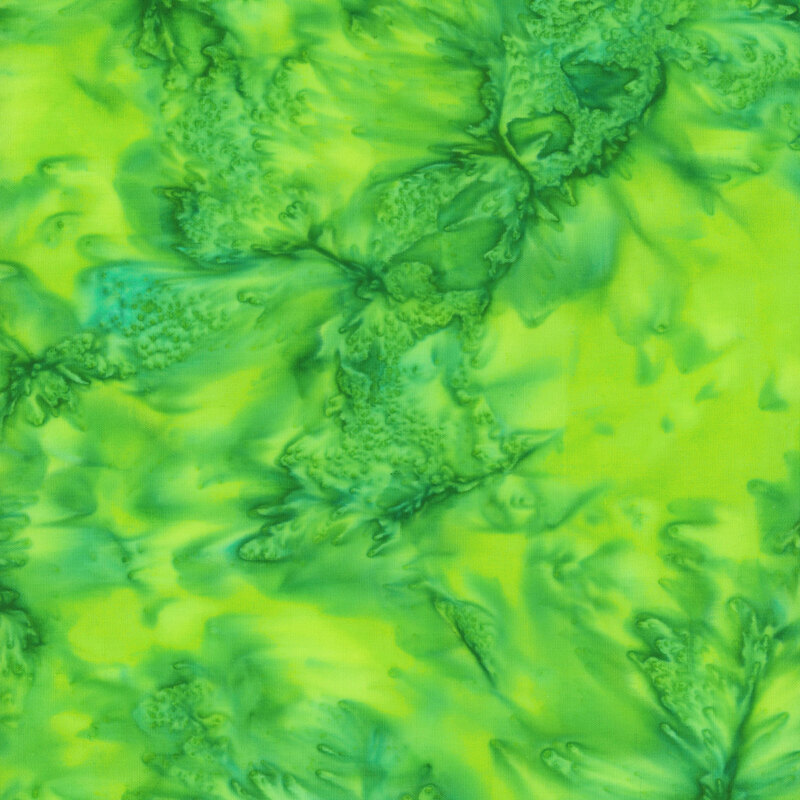 Marbled batik fabric in shades of yellow green.