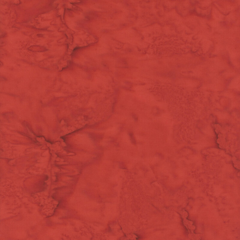 Marbled batik fabric in shades of red.