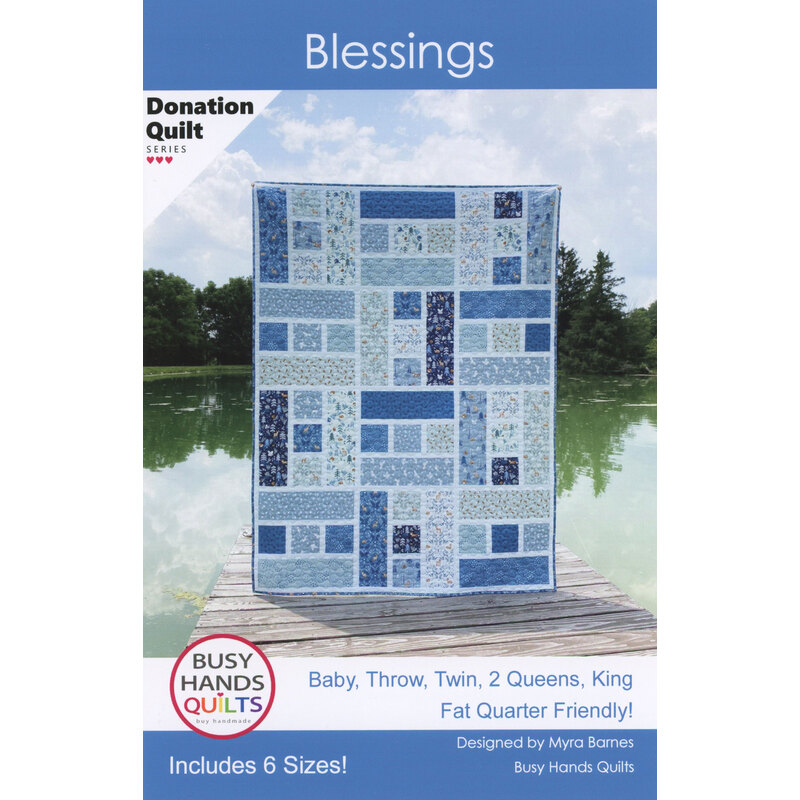 A blue and white quilt displayed outdoors, featuring a patchwork design, titled Blessings.