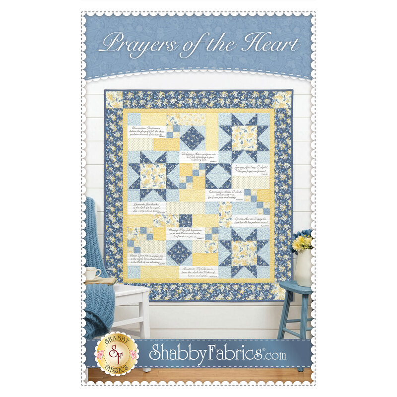 The front cover of the Prayers of the Heart pattern. A finished a blue and yellow quilt hangs on a white paneled wall with coordinating décor on the front cover. 