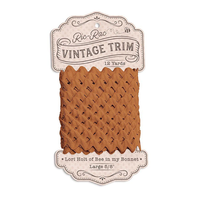 A spool of large caramel brown ric-rac trim on a white background