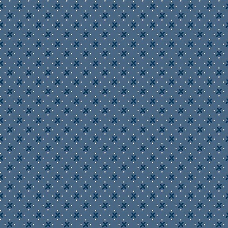 A simple pattern of navy blue x's and white dots on a faded blue denim background