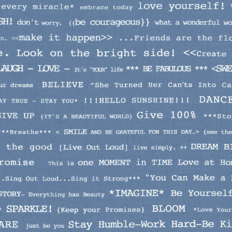 Faded blue fabric with lines of white typewriter text saying with phrases such as "Be your own kind of beautiful" and "You are my sunshine"