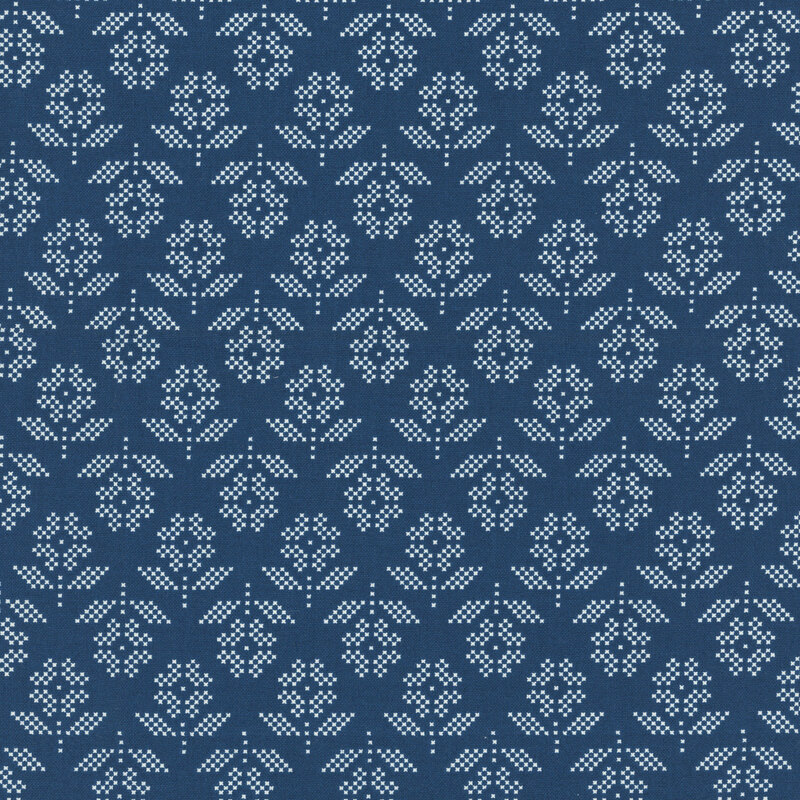 Navy fabric with a cross-stitch style pattern of white daisies