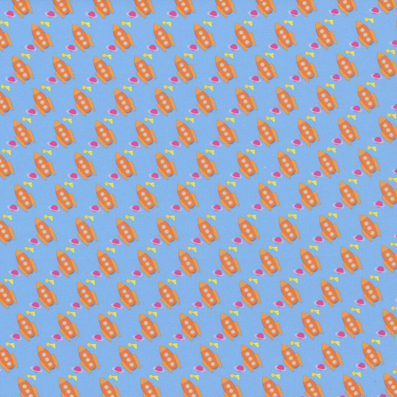 Sky blue fabric with a uniform pattern of diagonal orange rockets, pink planets, and yellow shooting stars