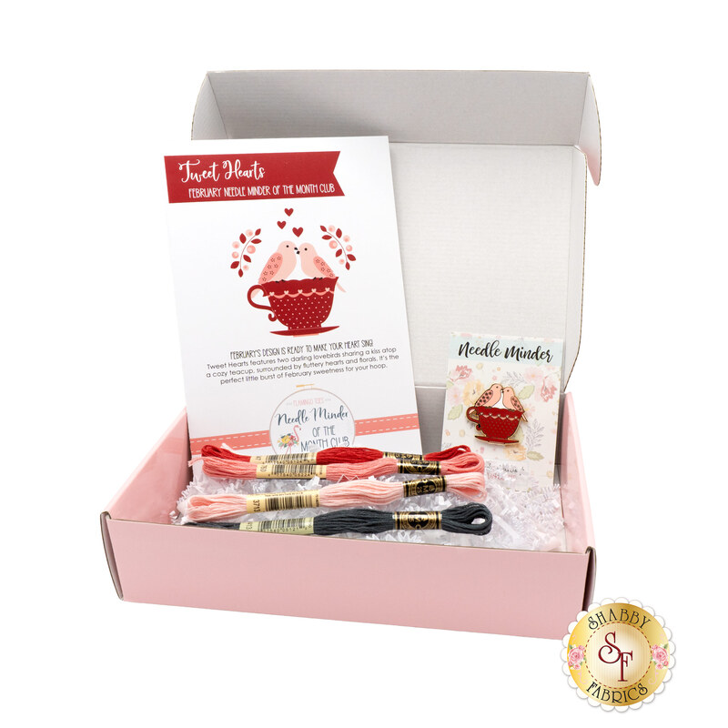 The February Needle Minder of the Month box, open and showing the contents, from the pattern to the floss and needle minder.