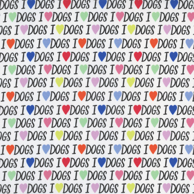 White fabric featuring the text "I love dogs" repeated with hearts instead of the word 'love.'