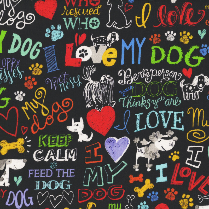 Black fabric with chalk stylized text and illustrations of dogs, bones, and hearts expressing love for dogs.