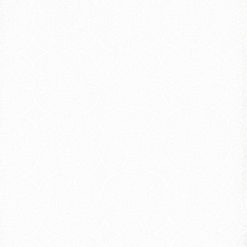 White on white fabric featuring geometric medallions.