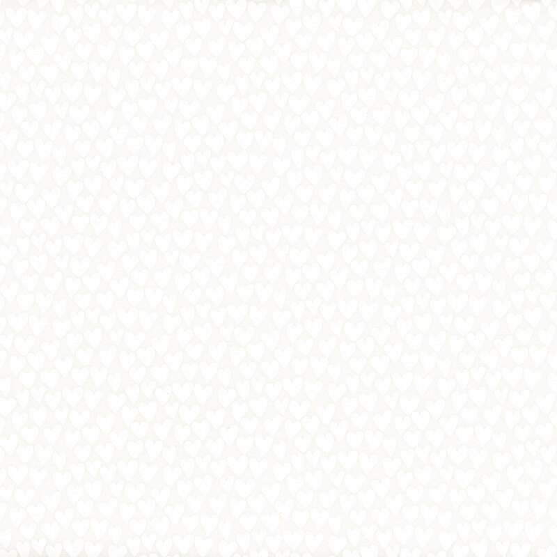 White on white muslin fabric packed with hearts.