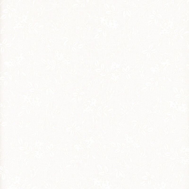 White on white muslin fabric featuring flowers and leafy vines.