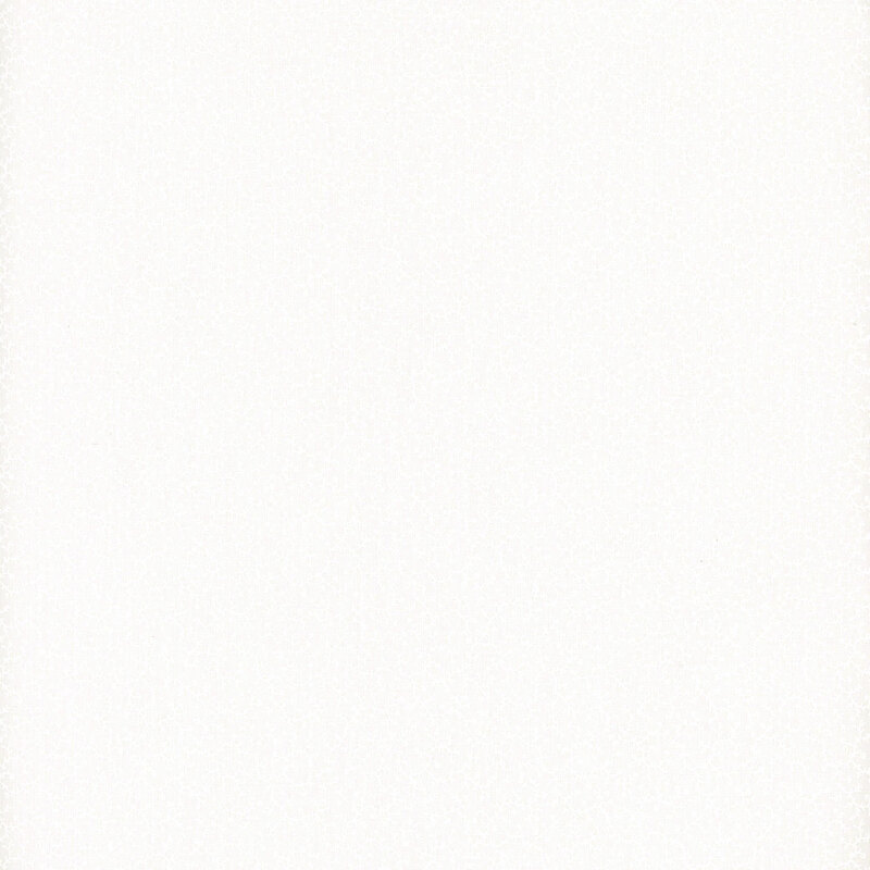 White on white muslin fabric featuring delicate leafy vines.