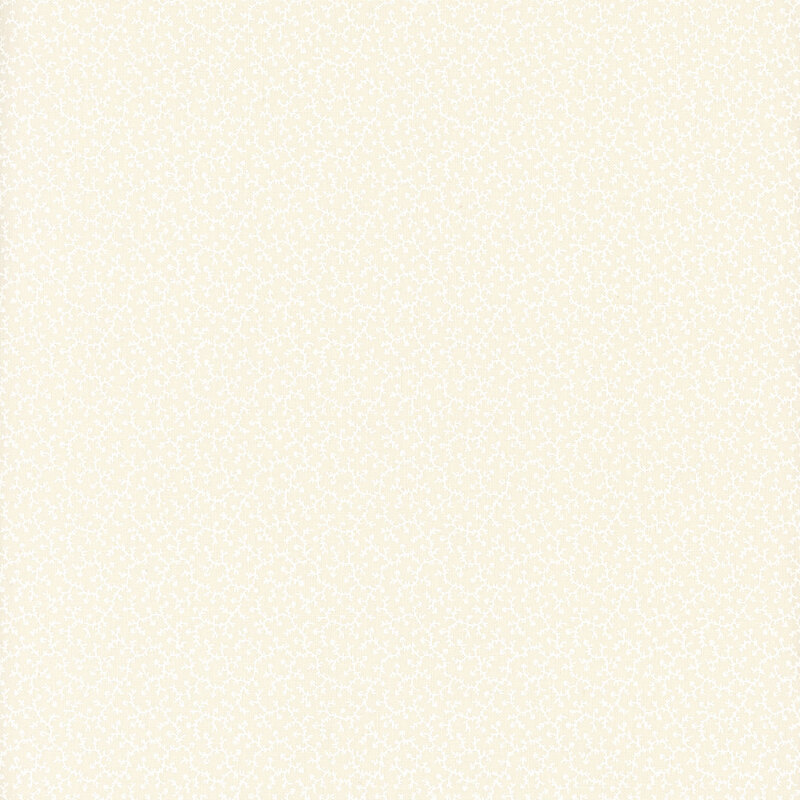 White on cream muslin fabric featuring delicate leafy vines.