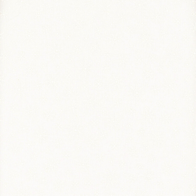 White on white muslin fabric featuring snowflakes.