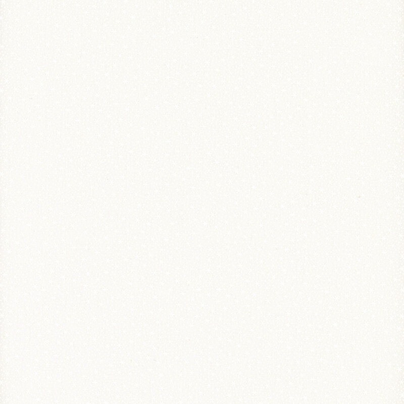 White on white muslin fabric featuring very tiny snowflakes.