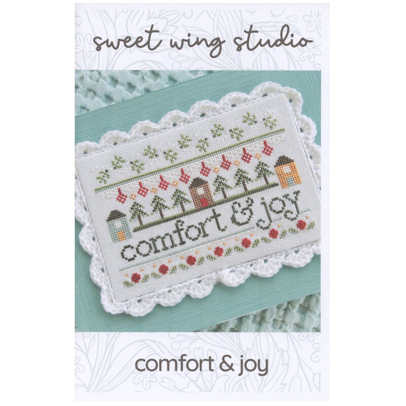 The front of the Comfort & Joy cross stitch pattern, showing the completed project with coordinating décor.
