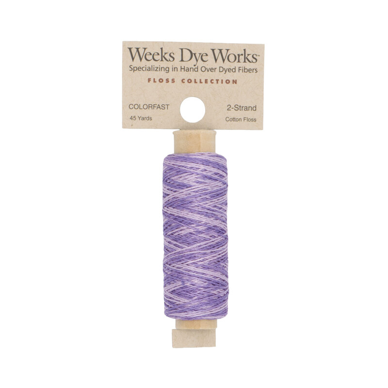 A spool of light and medium purple embroidery floss with a tan label featuring the brand name and color information.