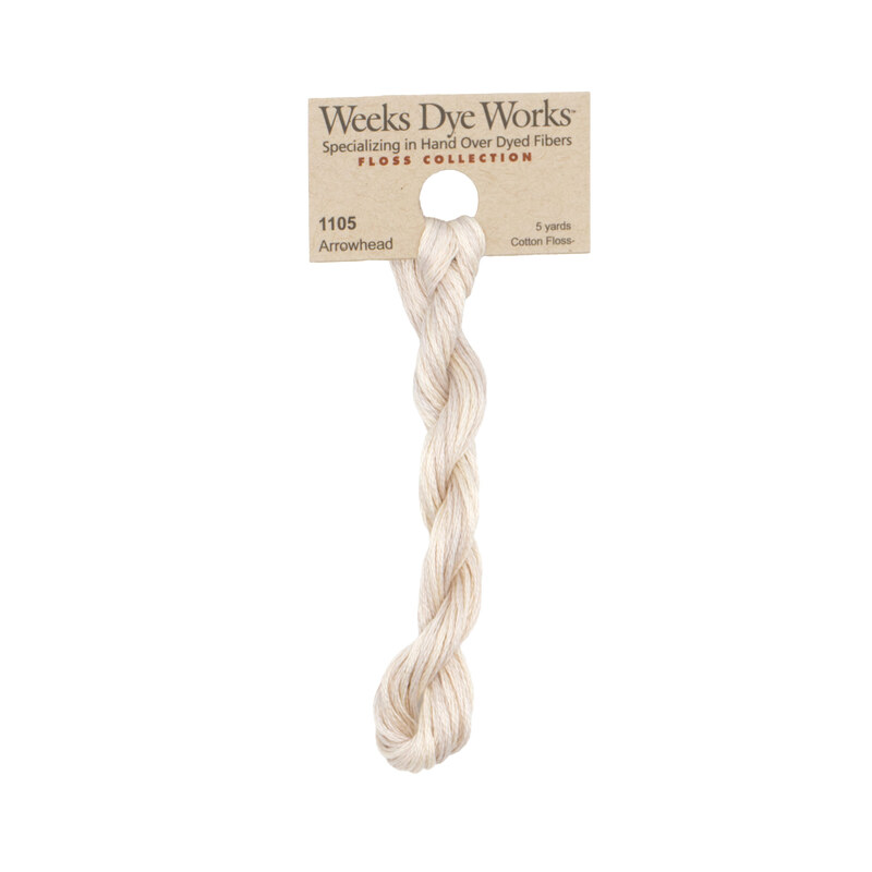 A skein of Sand Tan embroidery floss, twisted and bundled, with a tan label featuring the brand name and color information.