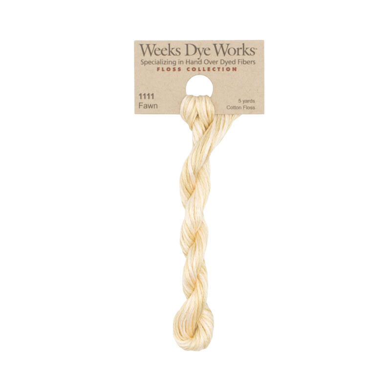 A skein of pale beige embroidery floss, twisted and bundled, with a tan label featuring the brand name and color information.
