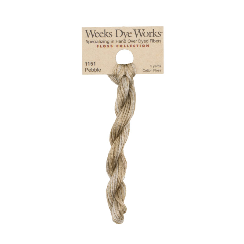 A skein of Khaki embroidery floss, twisted and bundled, with a tan label featuring the brand name and color information.