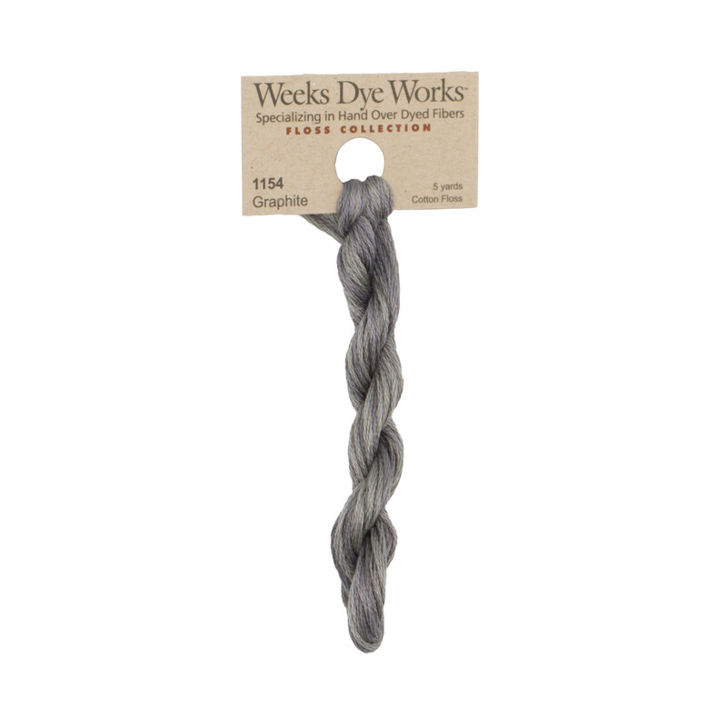 A skein of gray embroidery floss, twisted and bundled, with a tan label featuring the brand name and color information.