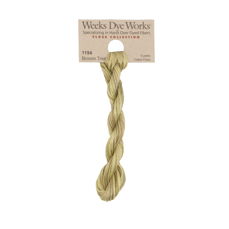 A skein of lemongrass embroidery floss, twisted and bundled, with a tan label featuring the brand name and color information.