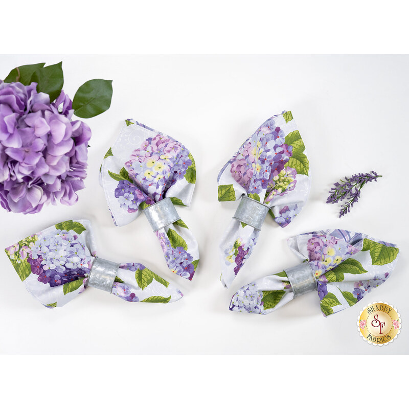 The four completed cloth napkins colored in periwinkle fabrics from the Hydrangeas In The Garden collection.