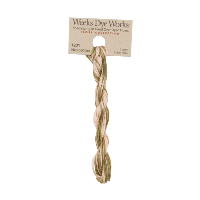 A skein of variegated pale olive and pink embroidery floss, twisted and bundled, with a tan label featuring the brand name and color information.