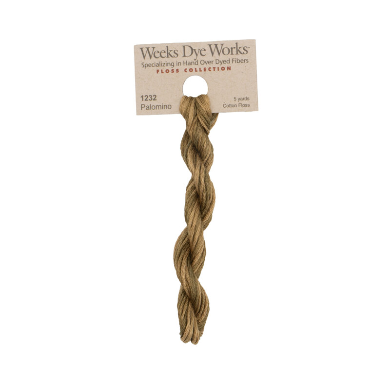 A skein of brown embroidery floss, twisted and bundled, with a tan label featuring the brand name and color information.
