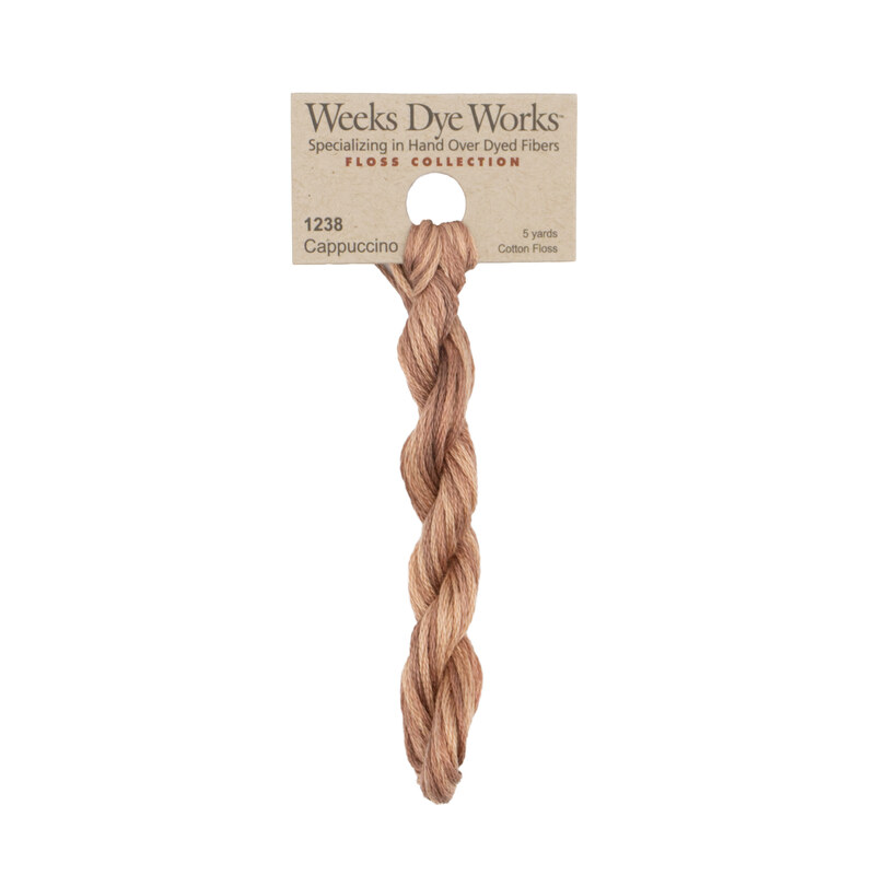 A skein of cappuccino brown embroidery floss, twisted and bundled, with a tan label featuring the brand name and color information.