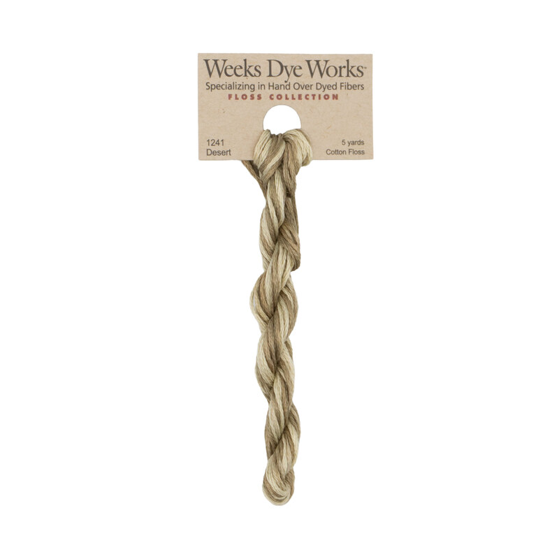 A skein of green and brown embroidery floss, twisted and bundled, with a tan label featuring the brand name and color information.