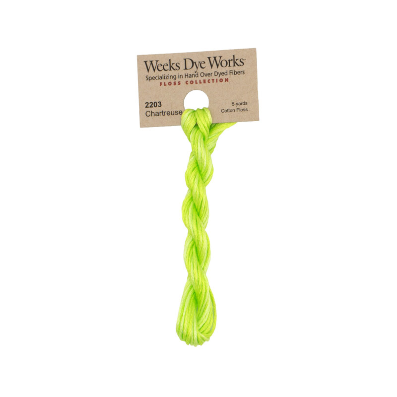 A skein of lime green embroidery floss, twisted and bundled, with a tan label featuring the brand name and color information.