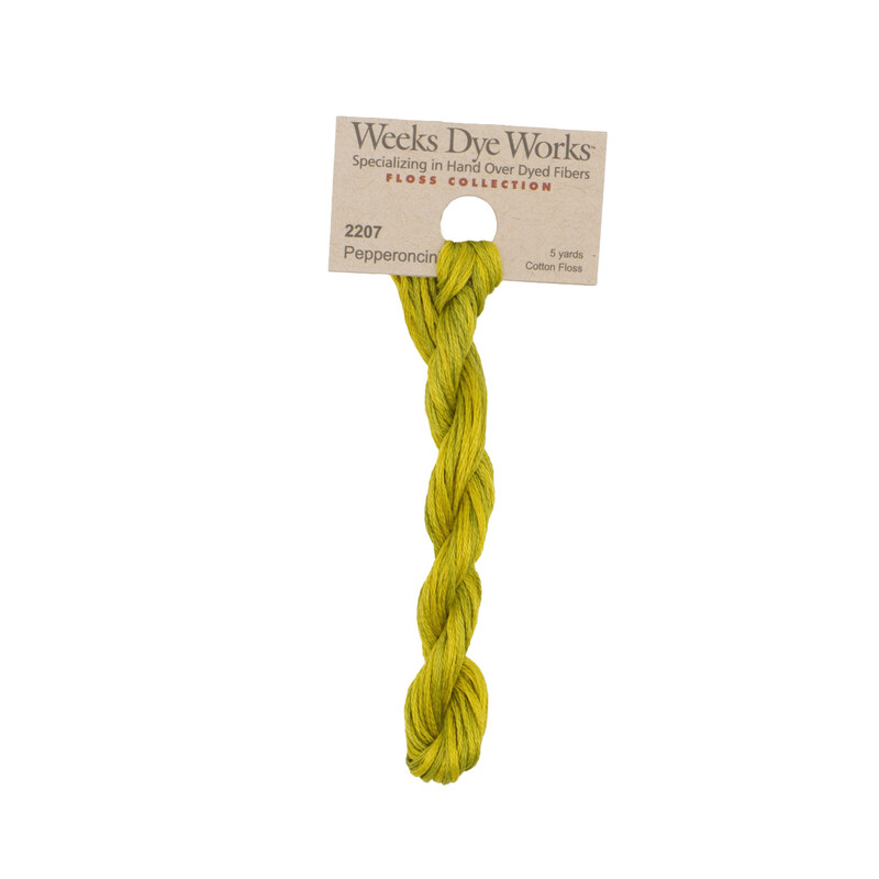 A skein of dark cintrine embroidery floss, twisted and bundled, with a tan label featuring the brand name and color information.