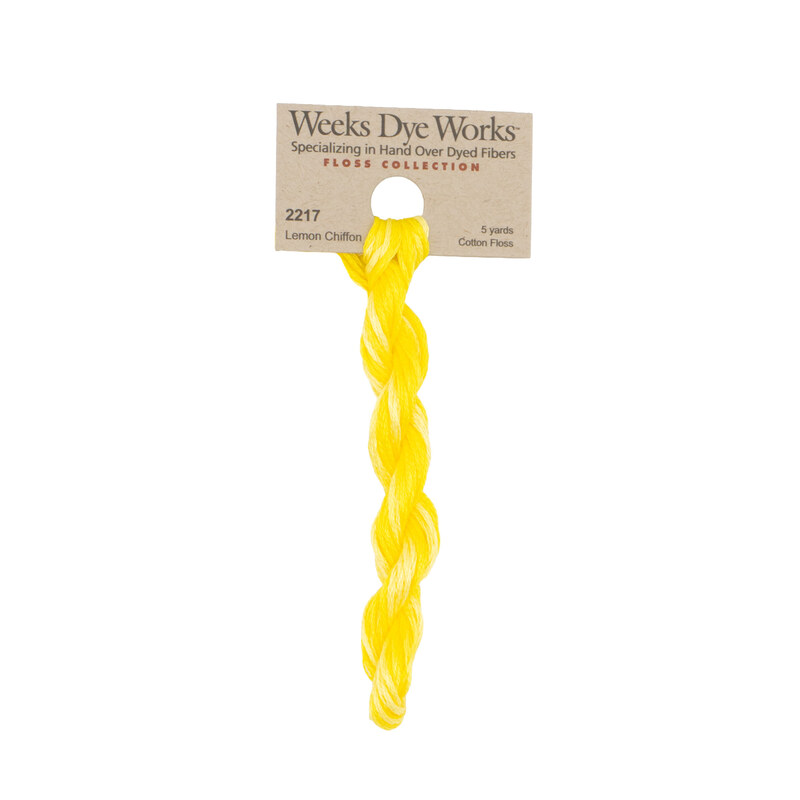 A skein of highlighter yellow embroidery floss, twisted and bundled, with a tan label featuring the brand name and color information.