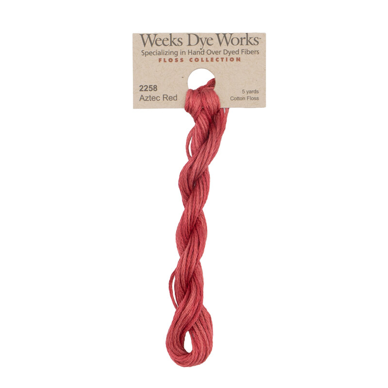 A skein of Garnet Red embroidery floss, twisted and bundled, with a tan label featuring the brand name and color information.