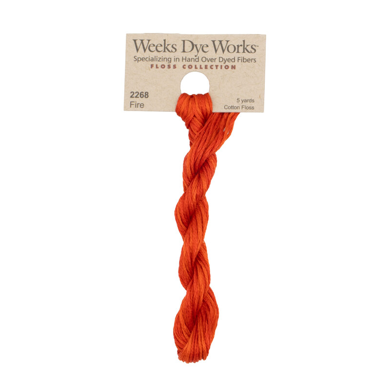 A skein of Bright Orange Red embroidery floss, twisted and bundled, with a tan label featuring the brand name and color information.