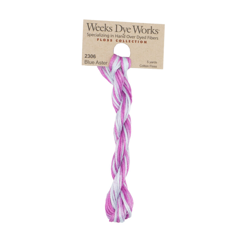 A skein of variegated baby blue and magenta embroidery floss, twisted and bundled, with a tan label featuring the brand name and color information.