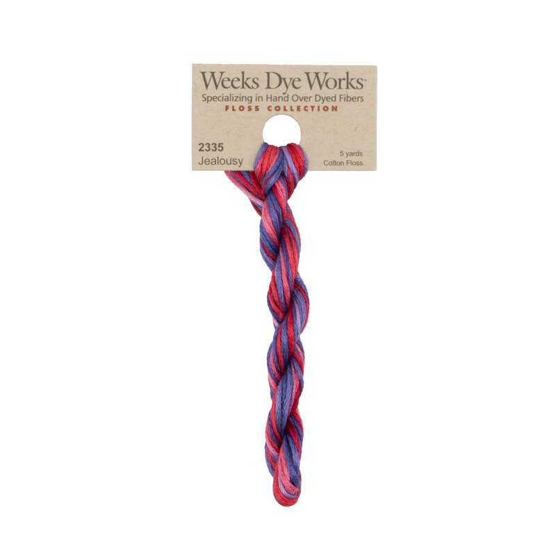 A skein of Variegated Hot Pink and Dark Purple embroidery floss, twisted and bundled, with a tan label featuring the brand name and color information.