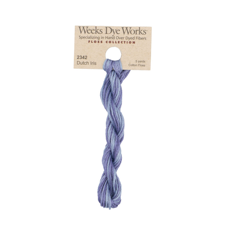 A skein of powder blue embroidery floss, twisted and bundled, with a tan label featuring the brand name and color information.