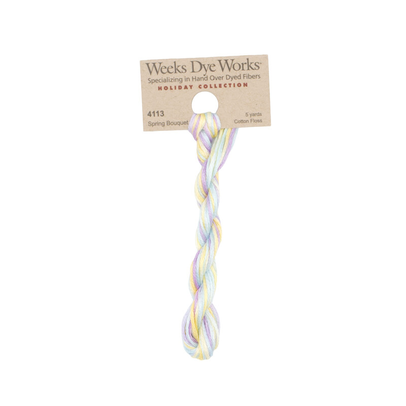 A skein of Variegated Pastels embroidery floss, twisted and bundled, with a tan label featuring the brand name and color information.