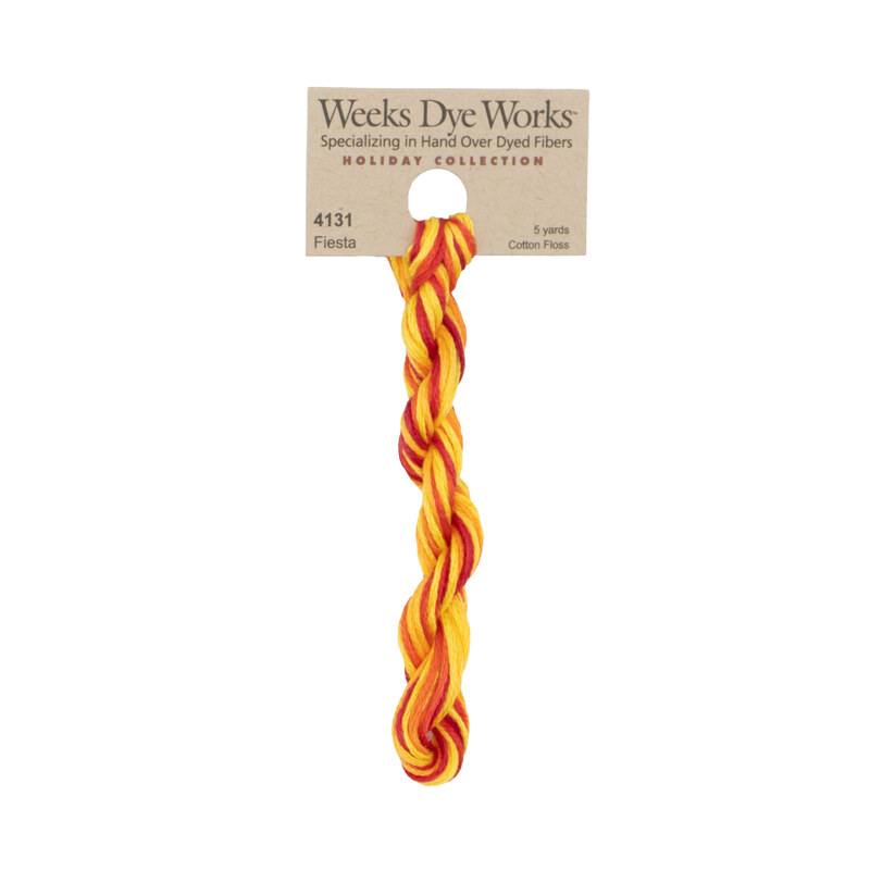A skein of flame red, orange, and yellow embroidery floss, twisted and bundled, with a tan label featuring the brand name and color information.