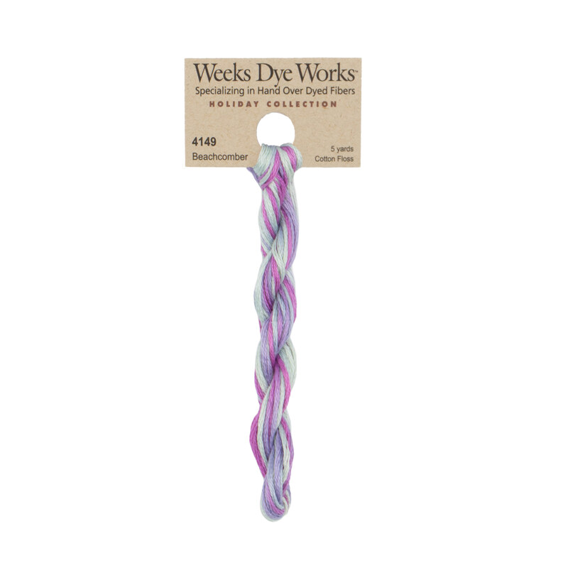 A skein of Variegated Sky Blue, Lavender, and Purple embroidery floss, twisted and bundled, with a tan label featuring the brand name and color information.