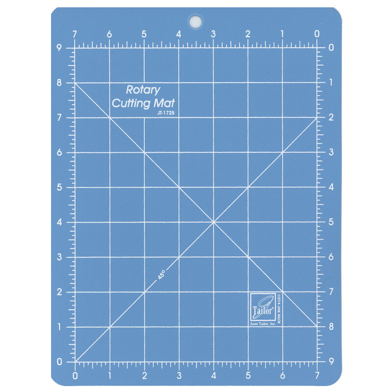 Blue rotary cutting mat with with perpendicular lines measuring up to 7 inches horizontally and 9 inches vertically