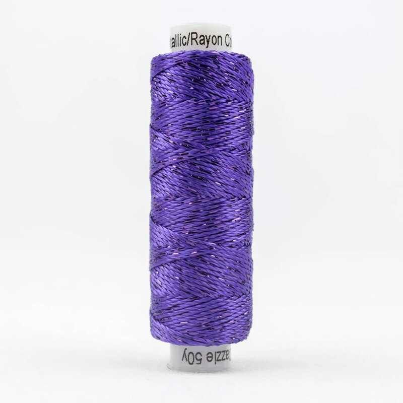 A spool of WonderFil Dazzle 5118 - Prism Violet thread on a white background