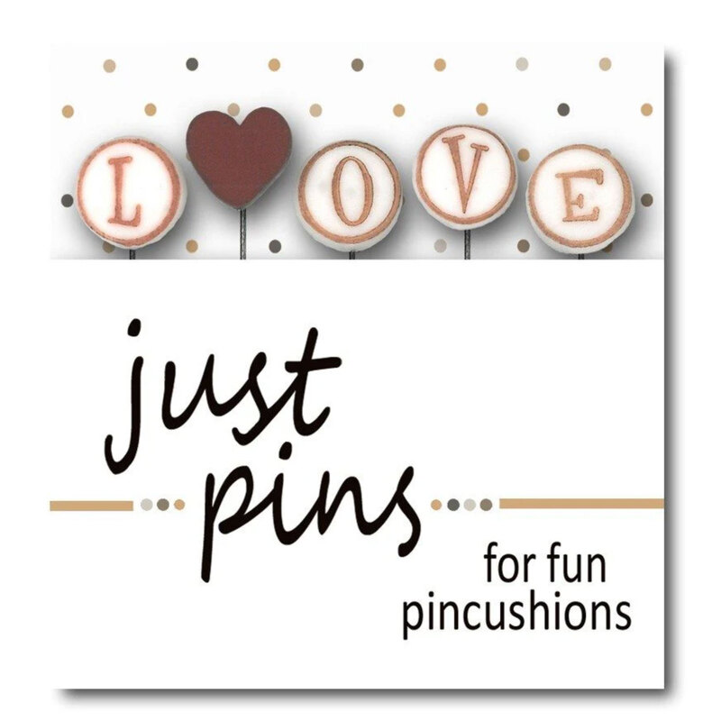 A digital mockup of the packaging edited with the real pins, showing pins that spell out the word love and a head heart pin.