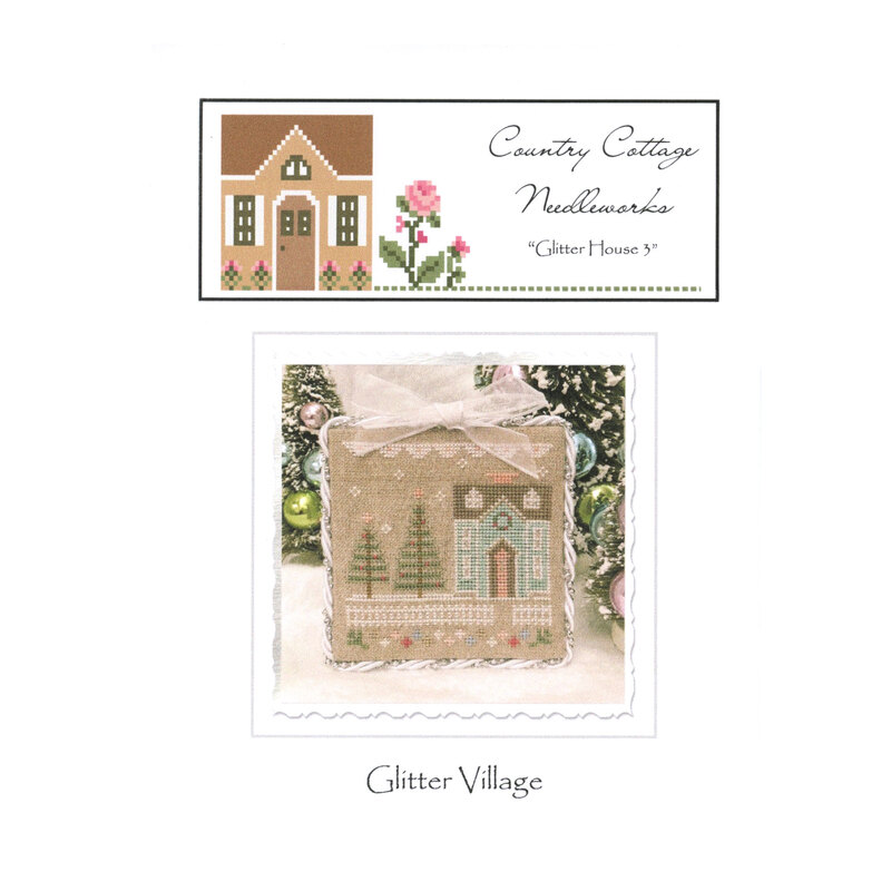 Front image of the "glitter house" pattern featuring a snowy scene with a blue house, white picket fence and pine trees.