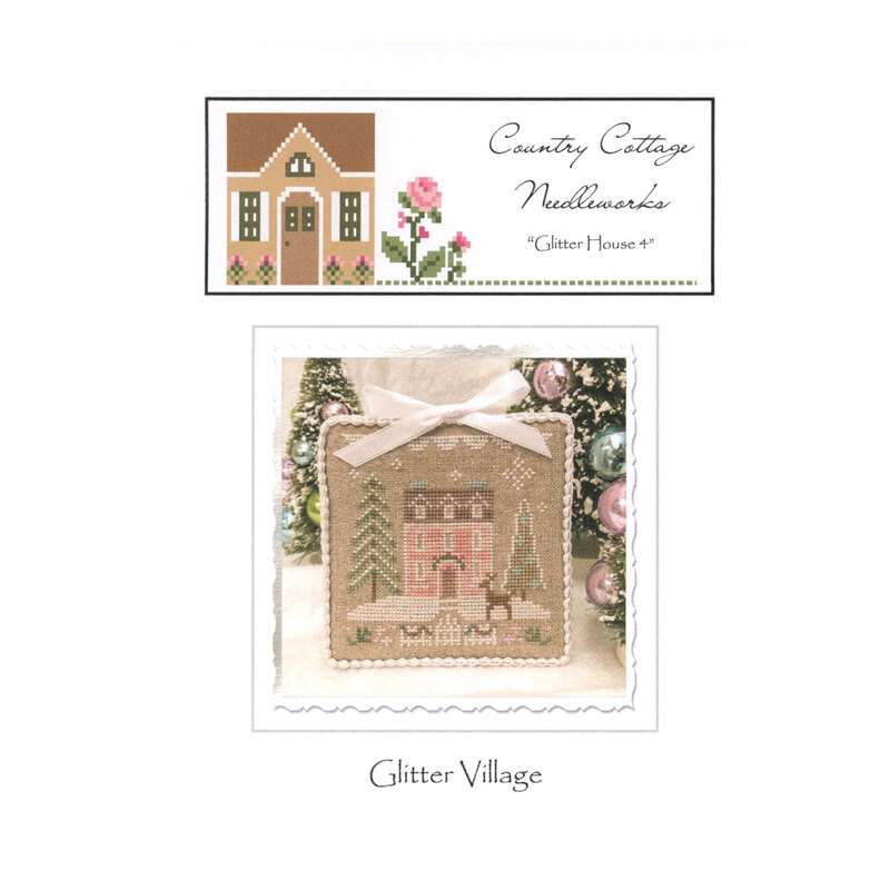 Front image of the "glitter house" pattern featuring a scene of a snow-covered pink house with pine trees and a deer