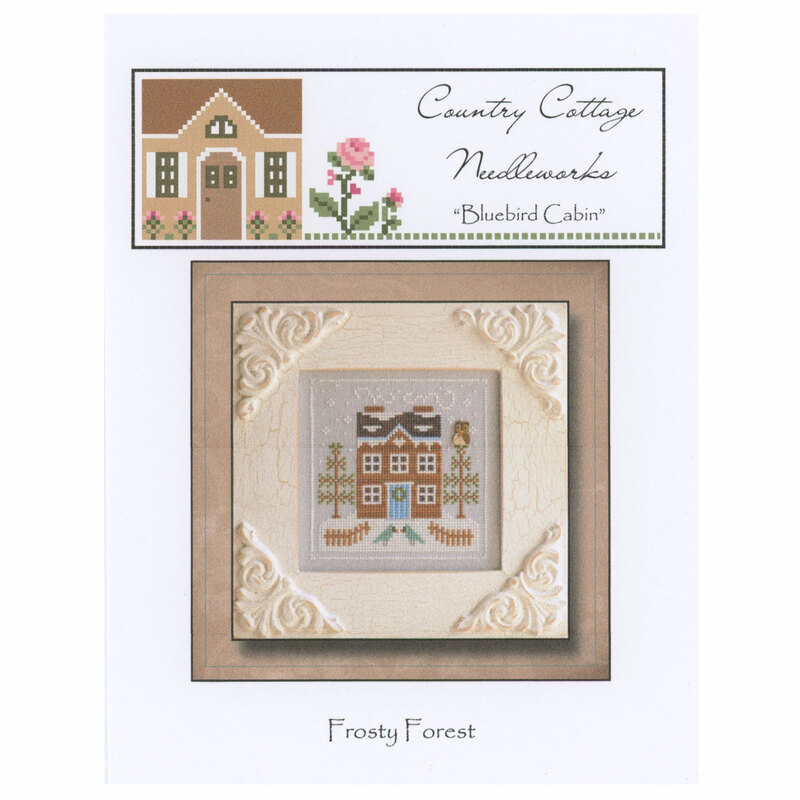 The front of the Frosty Forest Bluebird Cabin pattern featuring a snowy cabin with blue birds out front. 