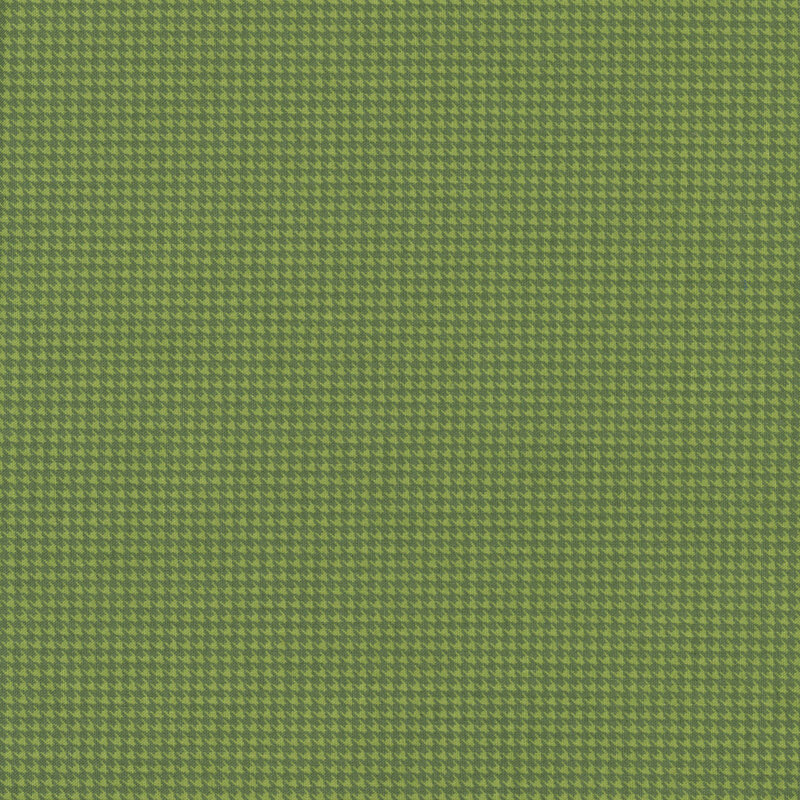 A houndstooth fabric swatch in tonal olive green hues.